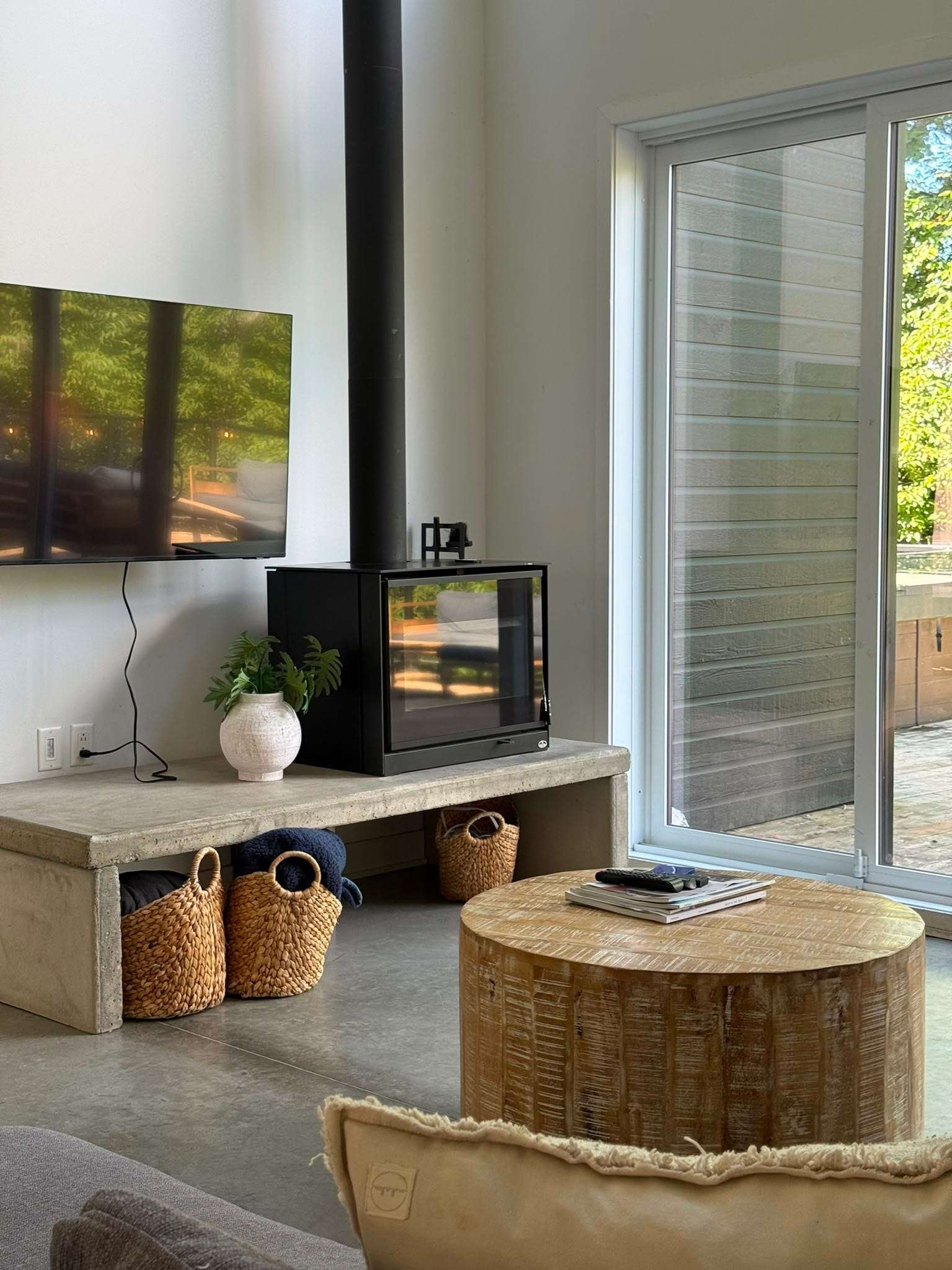 Living room with wood stove and patio door, checked between stays